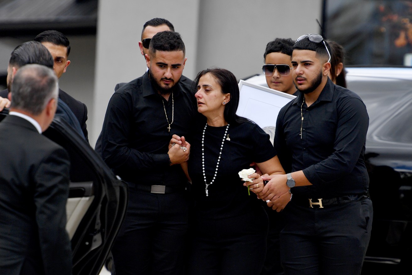 Family and friends are consoled during the funeral for helicopter crash victim Vanessa Tadros at St John The Beloved Church in Sydney. (AAP Image/Bianca De Marchi)