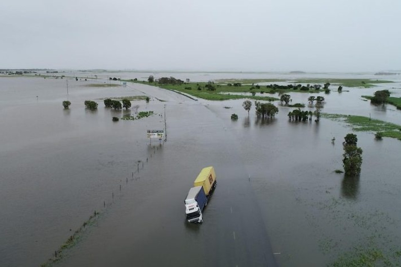 A stranded semi-trailer is dwarfed by the massive floodwaters near Mackay, with the possibility of a cyclone forming from the low pressure system. (ABC photograph).