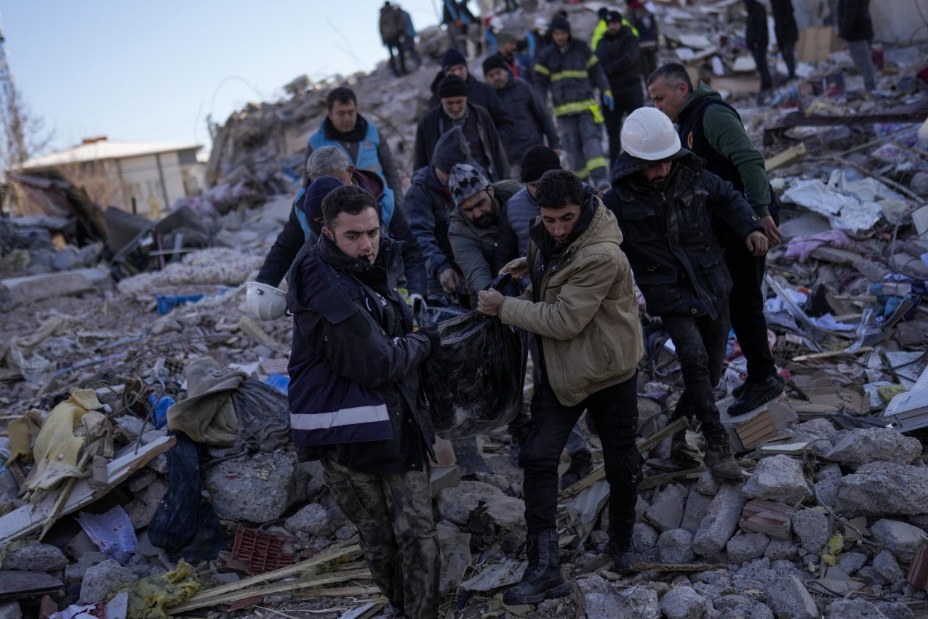 Tens of thousands of people who lost their homes in a catastrophic earthquake huddled around campfires in the bitter cold and clamored for food and water Thursday, three days after the temblor hit Turkey and Syria. (AP Photo/Francisco Seco)