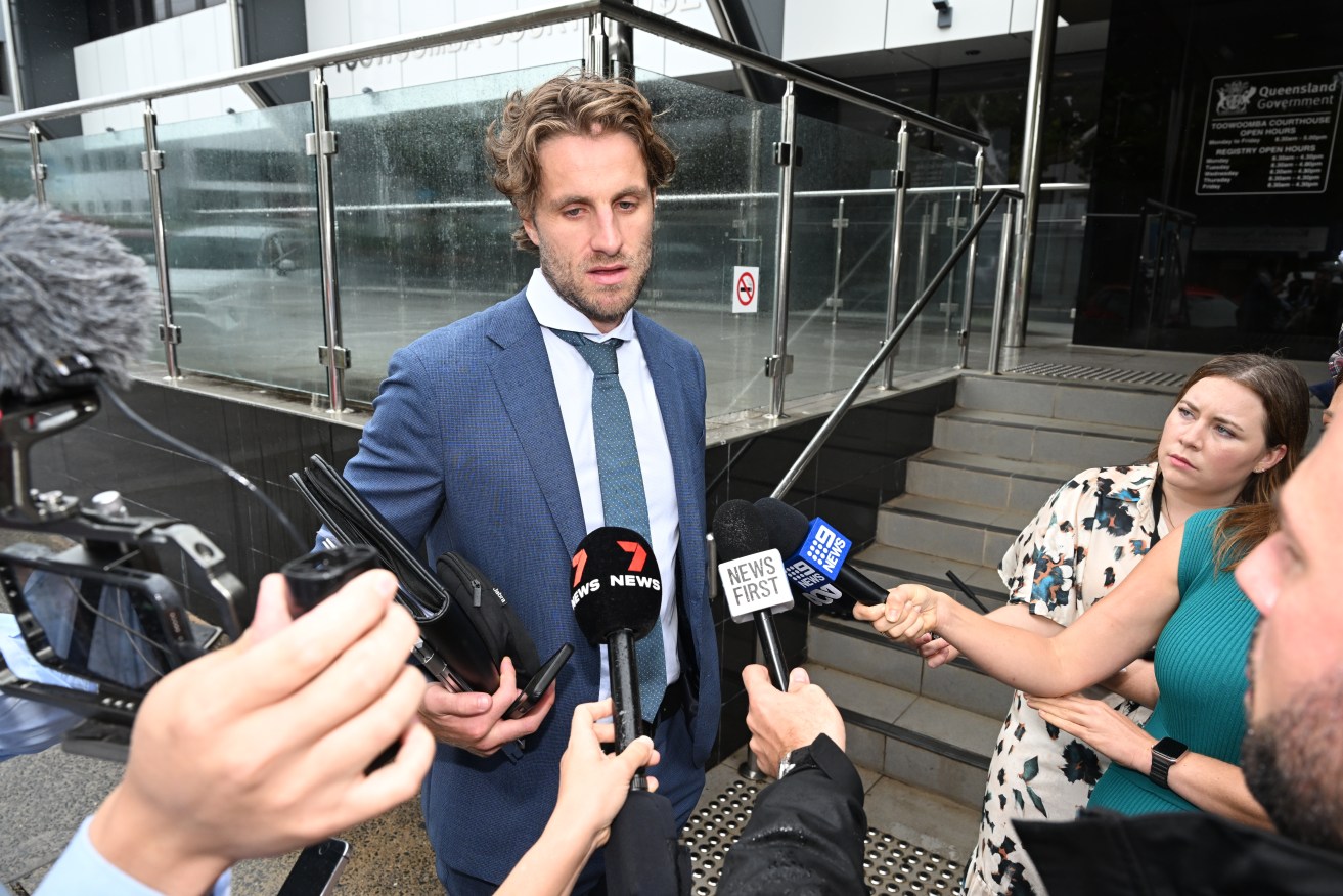 Media Lawyer Xander Croft (centre) outside Toowoomba Magistrates Court. (AAP Image/Darren England) 