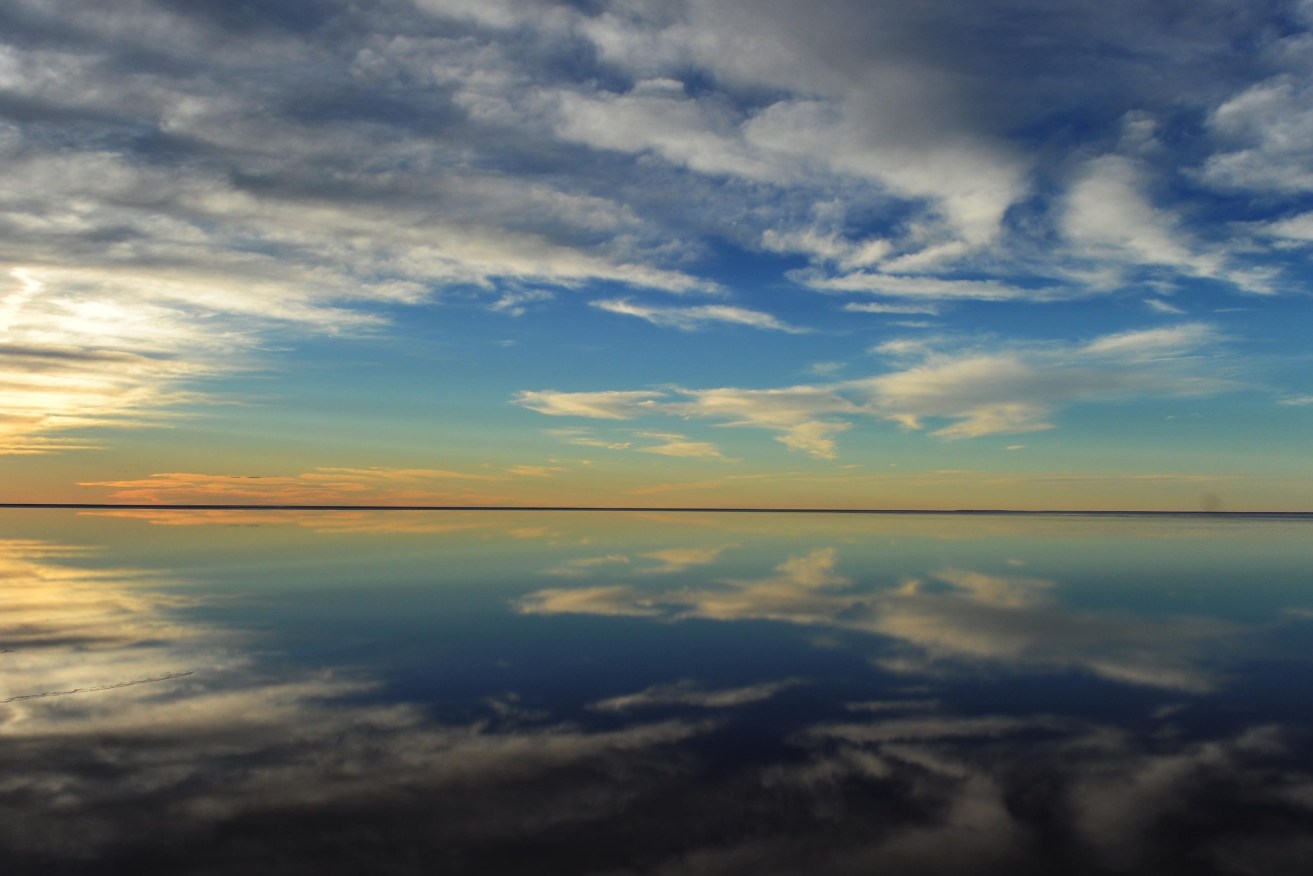 Sunset reflected in the waters of Lake Eyre in South Australia.(AAP Image/Dean Lewins)