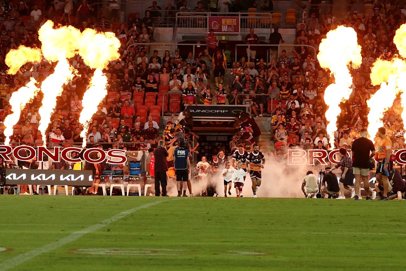 Adam Reynolds leads the Broncos out onto the Suncorp Stadium playing surface.  (AAP Image/Jason O'Brien) 