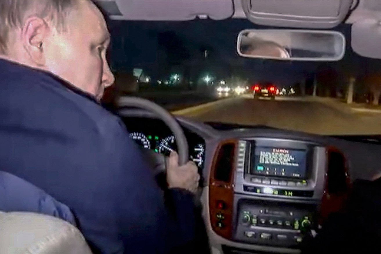 Russian President Vladimir Putin drives a car during his visit to Mariupol, eastern Ukraine. 