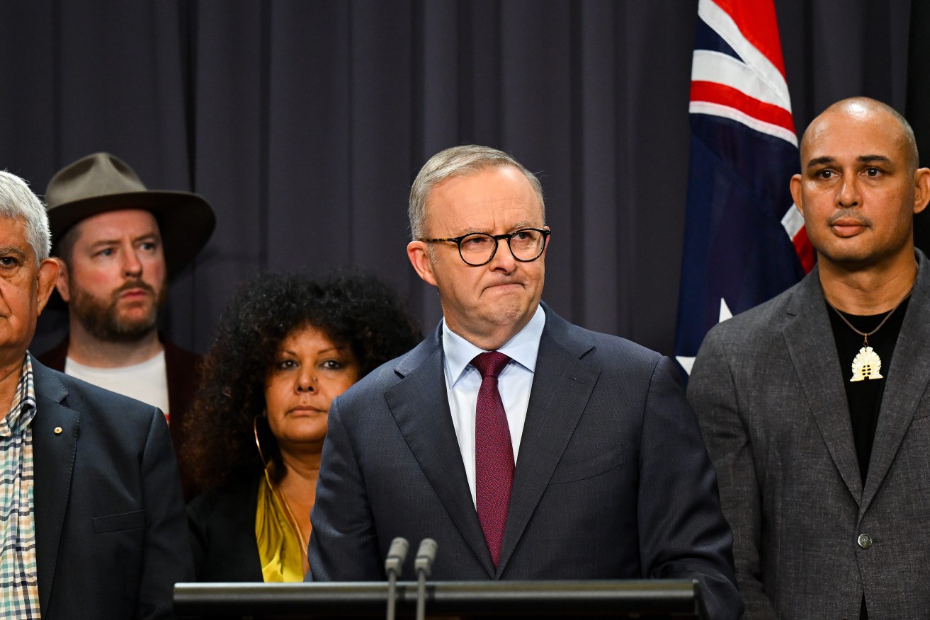 Australian Prime Minister Anthony Albanese surrounded by members of the First Nations Referendum Working Group speaks to the media during a press conference at Parliament House in Canberra, Thursday, March 23, 2023. (AAP Image/Lukas Coch
