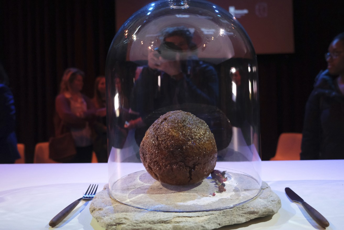 A meatball made using genetic code from the mammoth is seen at the Nemo science museum in Amsterdam, Tuesday March 28, 2023. An Australian company has lifted the glass cloche on a meatball made of lab-grown cultured meat using the genetic sequence from the long-extinct mastodon. The high-tech treat isn't available to eat yet - the startup says it is meant to fire up public debate about cultivated meat. (AP Photo/Mike Corder)