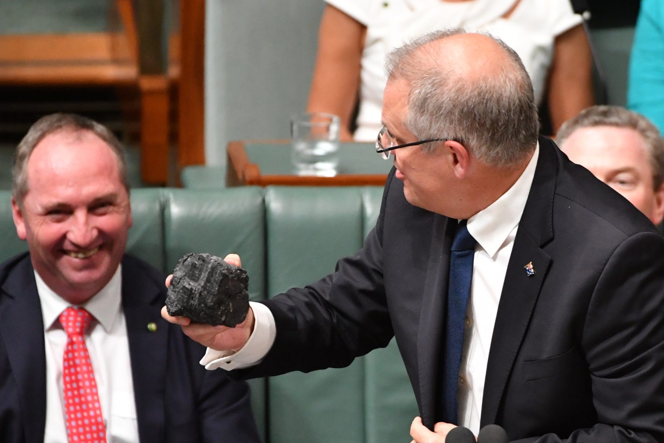 Treasurer Scott Morrison with a lump of coal during Question Time in the House of Representatives at Parliament House in Canberra, Thursday, Feb. 9, 2017. (AAP Image/Mick Tsikas) 