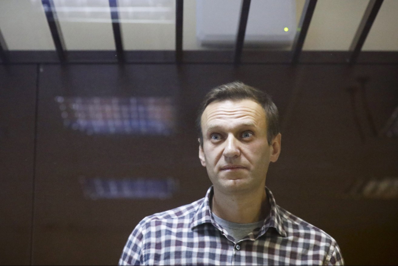 Russian opposition leader Alexei Navalny pictured standing in a cage in a Moscow court in 2021. (AP Photo/Alexander Zemlianichenko, File)