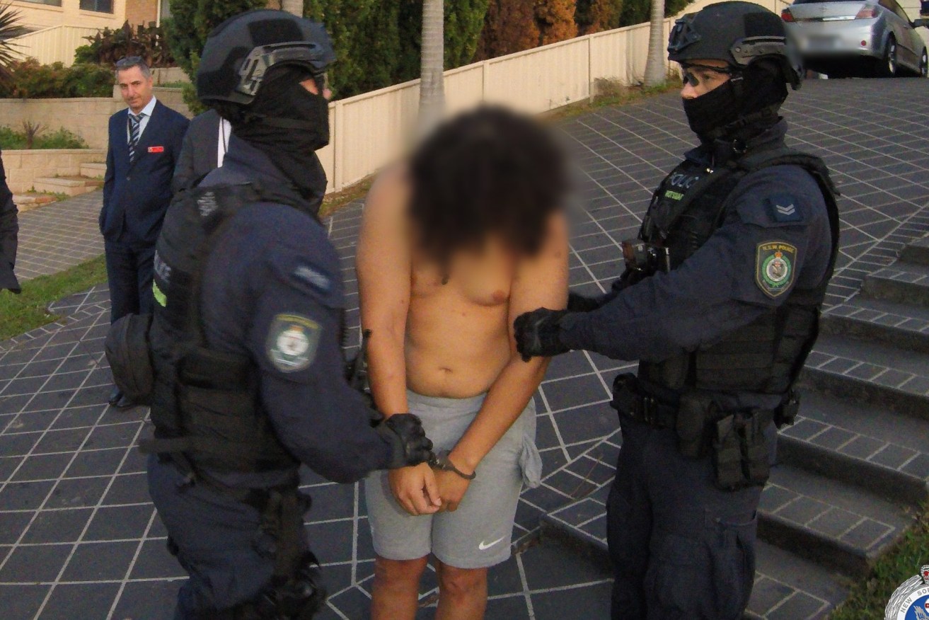 A supplied image shows NSW police raiding a home in Sydney's southwest, arresting a 25-year-old man who is charged with the murder of former bikie Yusuf Nazlioglu, Wednesday, April 19, 2023. (AAP Image/Supplied by NSW Police) 
