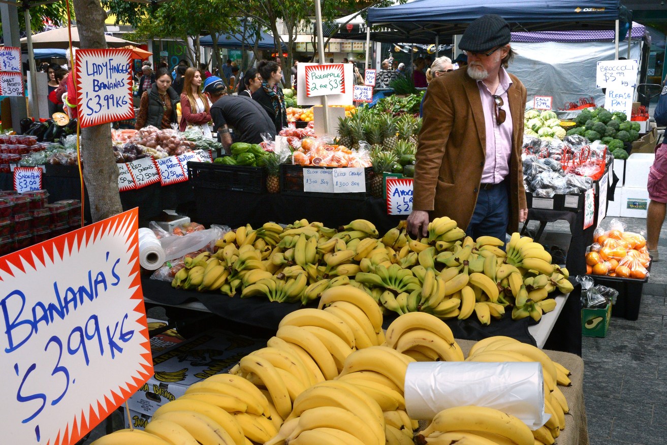 Shoppers are seen at a produce market in Brisbane. (AAP Image/Dave Hunt) 