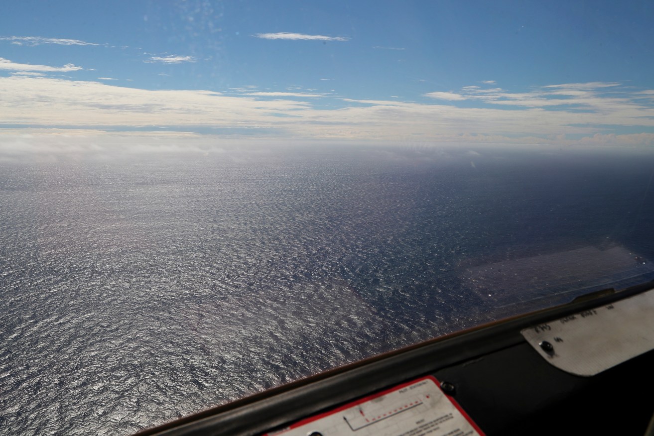 A vast open expanse is seen from an observers window onboard a Royal New Zealand Air Force P3 Orion while  searching for missing Malaysia Airlines Flight MH370 in the southern Indian Ocean, near the coast of Western Australia, Monday, March 31, 2014. (AP Photo/Rob Griffith)