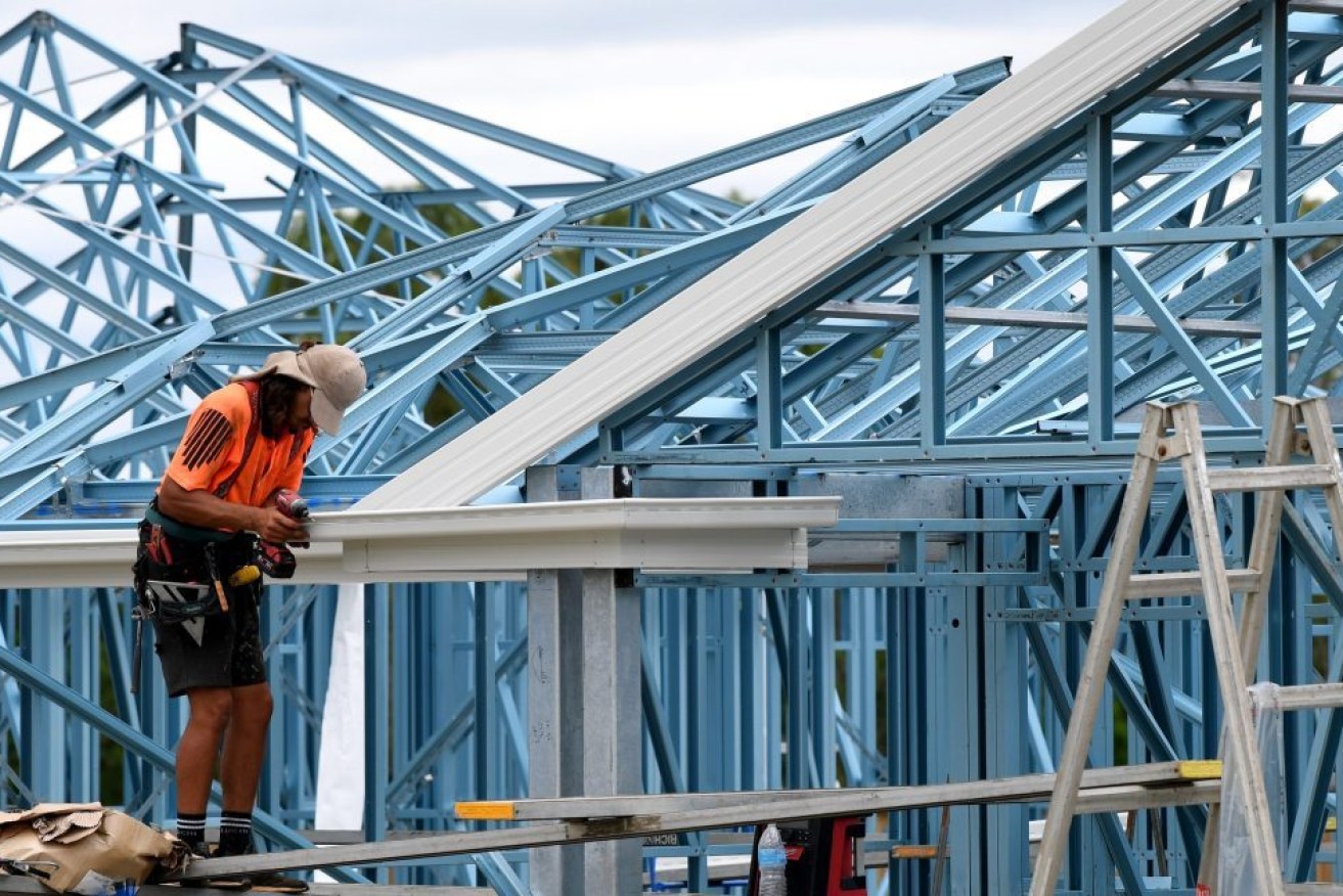 Roofer, Troy Phillips is seen constructing a new home in a housing estate at Coomera, on the Gold Coast, (AAP Image/Darren England)