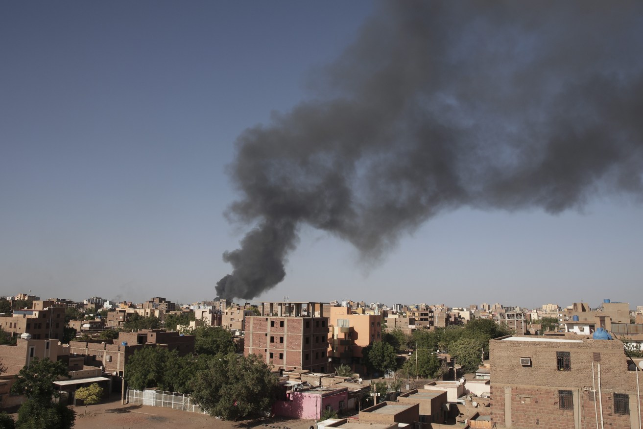Smoke is seen in Khartoum, Sudan, Wednesday, April 19, 2023. More than 200 Australians have been airlifted out of the war-torn country. (AP Photo/Marwan Ali, File)