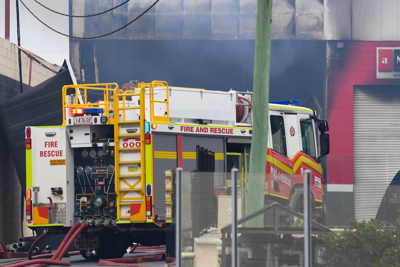 A damaged building at Freedom Pools, at the scene of a factory fire in Slacks Creek, in Logan, QLD, Tuesday, 2023. (AAP Image/Jono Searle)