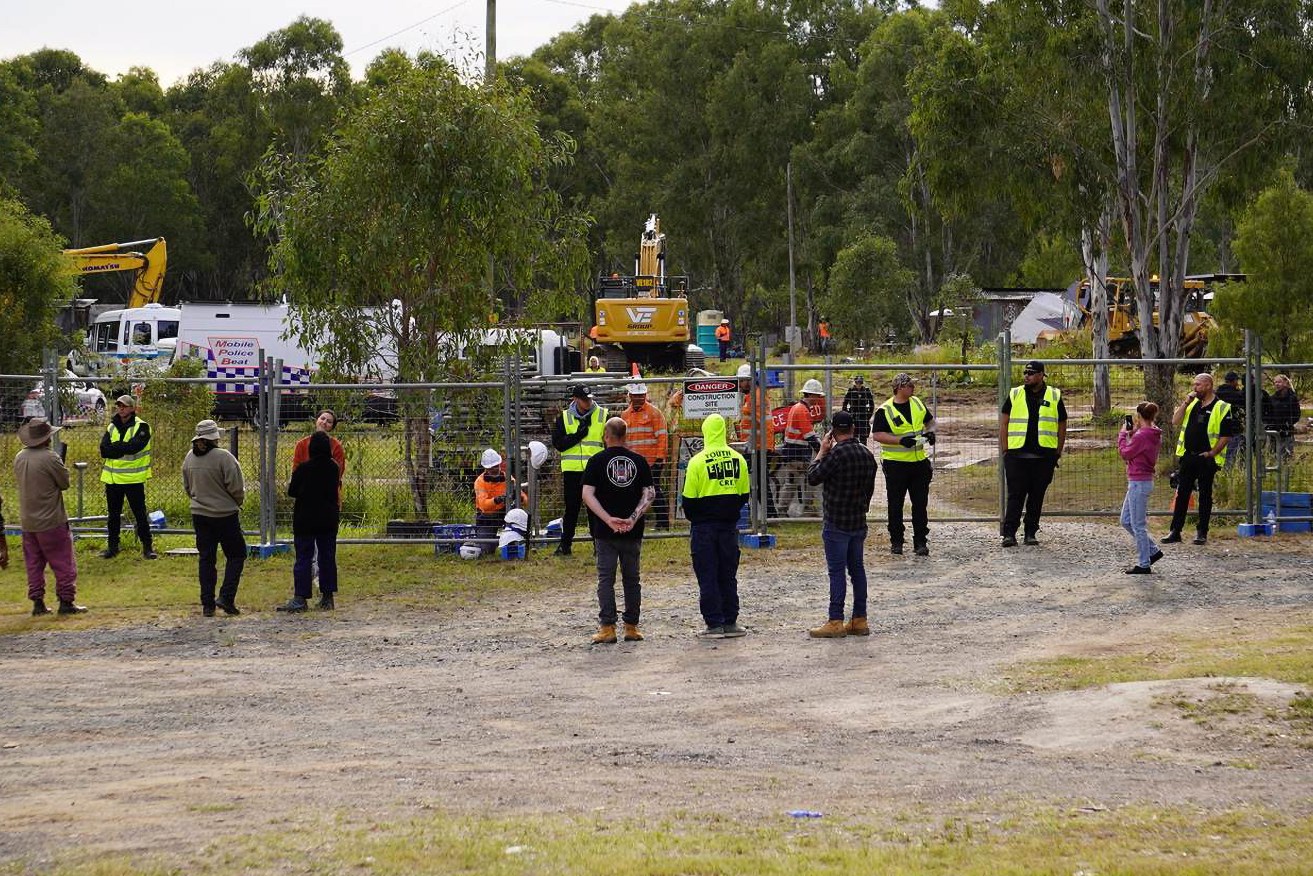 A supplied image shows police clearing protesters from a camp near the Deebing Creek Mission site near Ipswich, Queensland, Tuesday, May 2, 2023. A protester has been arrested at a proposed development at the Deebing Creek Aboriginal massacre site near Ipswich during a dawn police operation. (AAP Image/Supplied by Deebing Creek Justice)