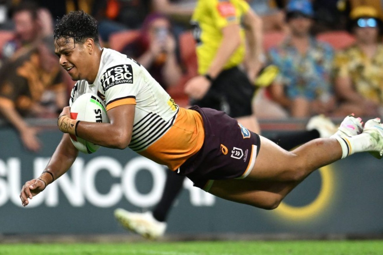 Selwyn Cobbo of the Broncos dives over to score a try during the NRL Magic Round match between the Manly-Warringah Sea Eagles and the Brisbane Broncos at Suncorp Stadium in Brisbane, Friday, May 5, 2023.  (AAP Image/Darren England) 