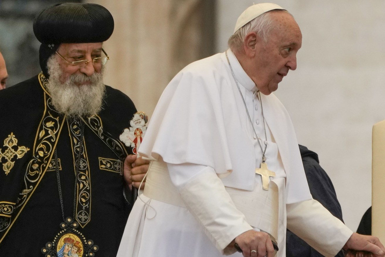 Pope Francis, right, arrives for his weekly general audience in St. Peter's Square at The Vatican, with the leader of the Coptic Orthodox Church of Alexandria, Tawadros II,Wednesday, May 10, 2023. (AP Photo/Alessandra Tarantino)