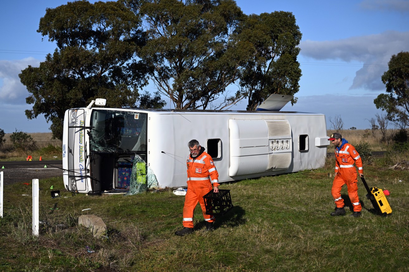 Emergency Services at the scene of a bus crash at the intersection of Exford Road and Murphys Road at Eynesbury, in Melbourne. On Tuesday, a bus carrying dozens of children collided with a truck in Melbourne's west, . (AAP Image/Joel Carrett) 