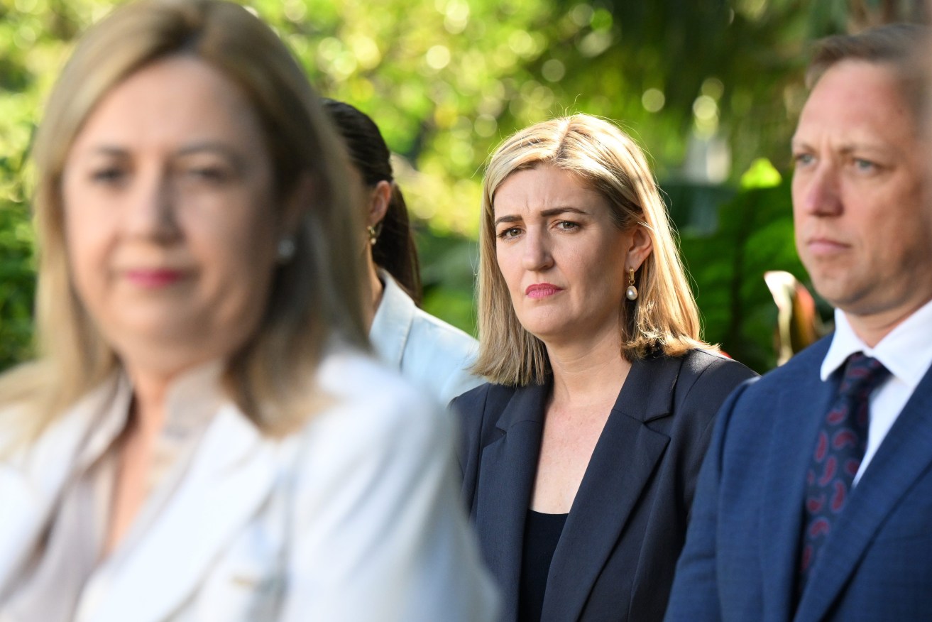 Shannon Fentiman (centre), the new Queensland Minister for Health and Ambulance Services, Mental Health and Women looks on as Queensland Premier Annastacia Palaszczuk (left) speaks during a press conference after a swearing-in ceremony following a cabinet reshuffle, at Government House in Brisbane. (AAP Image/Darren England)