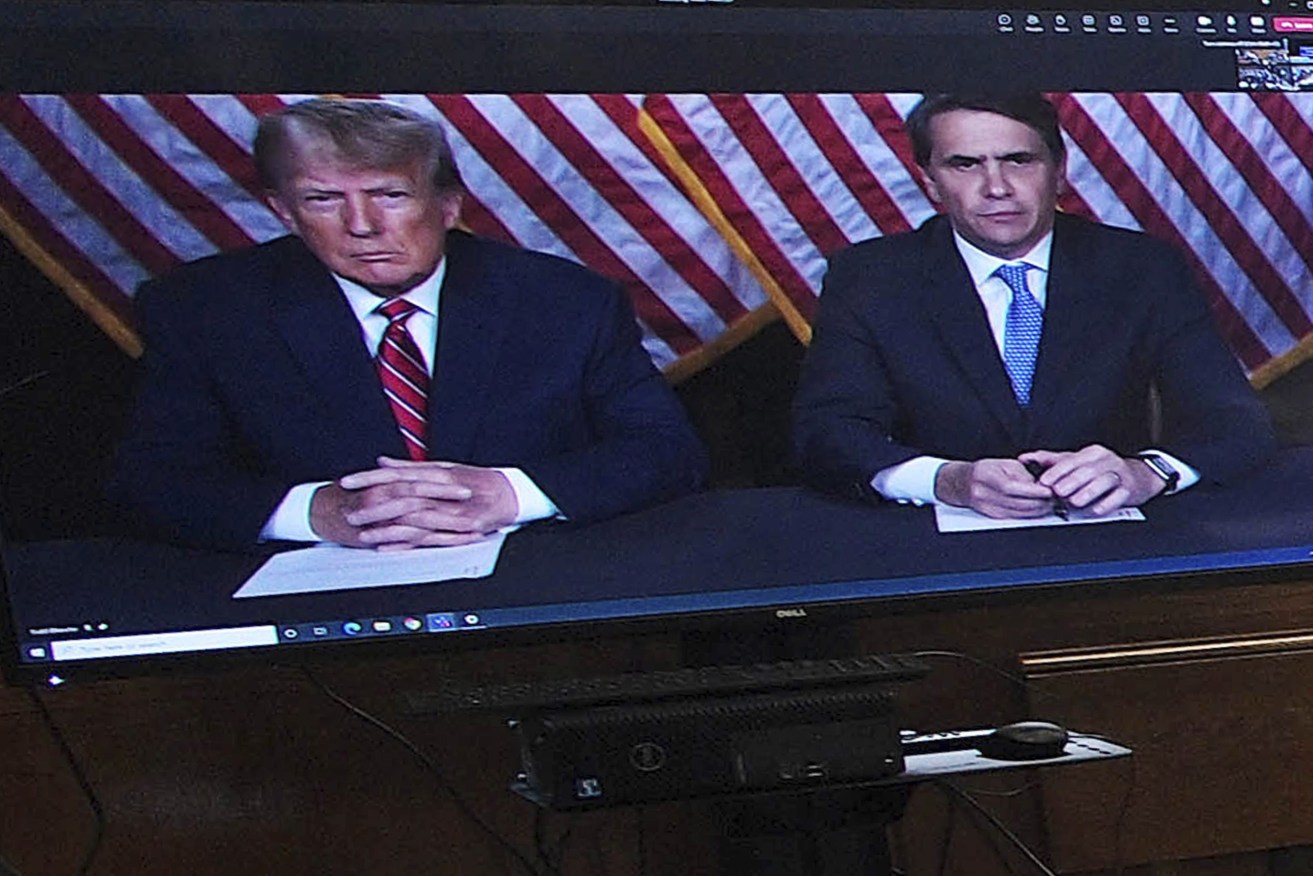 Former president Donald Trump, left on screen, and his attorney, Todd Blanche, right, appear by video before a hearing begins in Manhattan criminal court, in New York The judge set a trial date for late March of next year. (AP Photo/Curtis Means via Pool)
