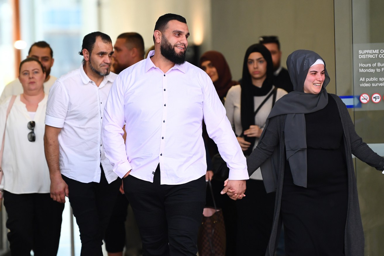 Osman El-Houli (centre) has been found not guilty after being accused of driving 3000km in a bid to collect $141 million worth of cocaine in far north Queensland.(AAP Image/Jono Searle) 