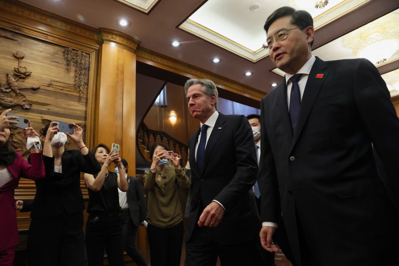 U.S. Secretary of State Antony Blinken, center, walks with Chinese Foreign Minister Qin Gang, right, at the Diaoyutai State Guesthouse in Beijing, China, Sunday. (Leah Millis/Pool Photo via AP)
