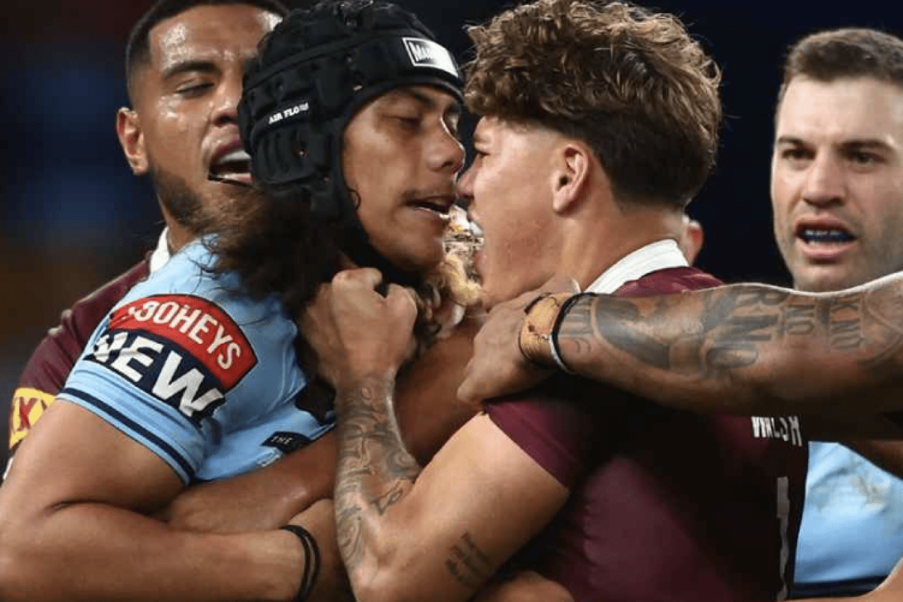 Jarome Luai of the Blues and Reece Walsh of the Maroons scuffle before being sent off for head butting. Chris Hyde/Getty Images