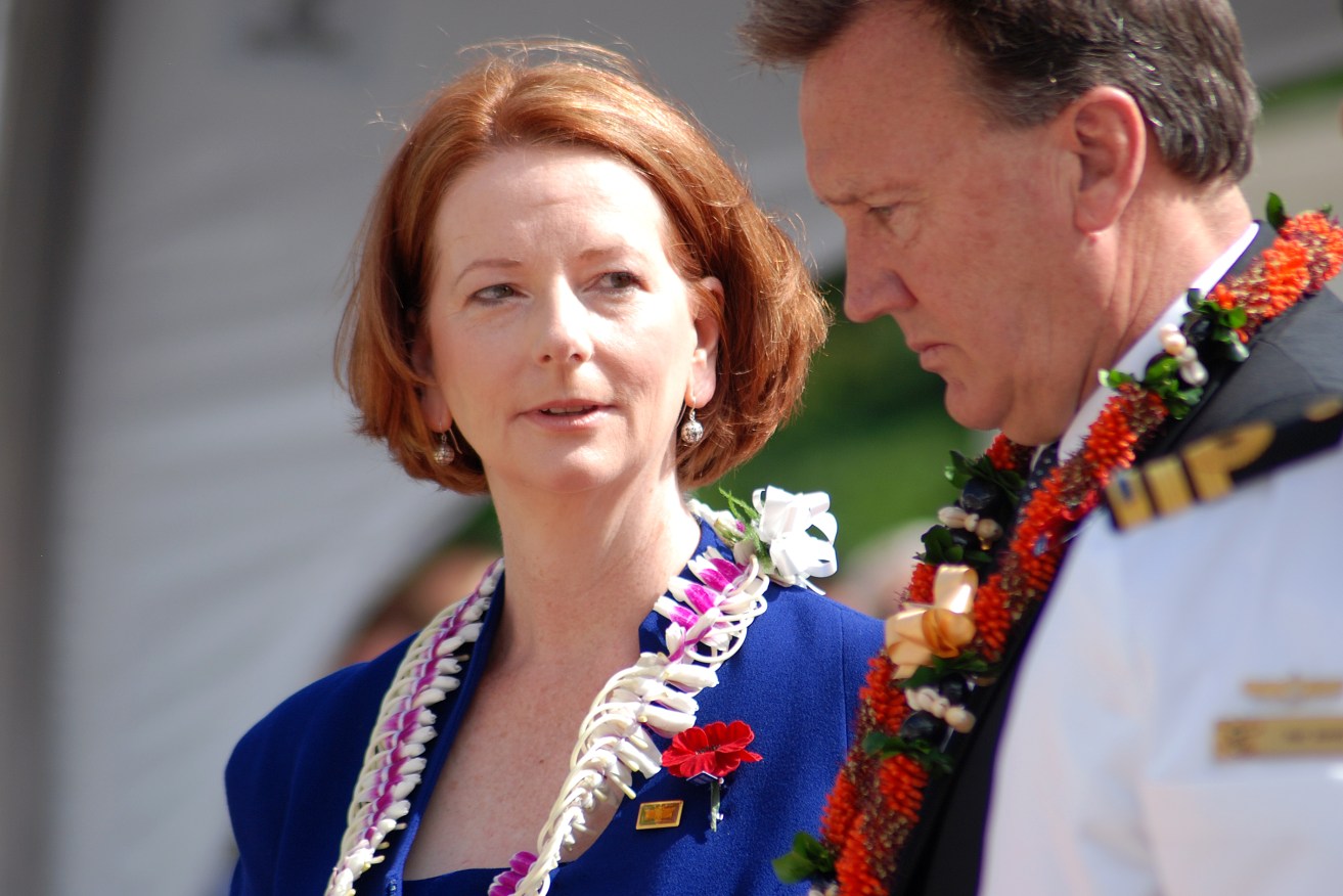 Prime Minister Julia Gillard looks at her partner Tim Mathieson during a Veterans Day ceremony at Honolulu's Punchbowl Cemetery in Hawaii on Friday, Nov. 11, 2011. It was Ms Gillard's first official engagement of her trip for the APEC leaders summit. (AAP Image/Adam Gartrell) NO ARCHIVING