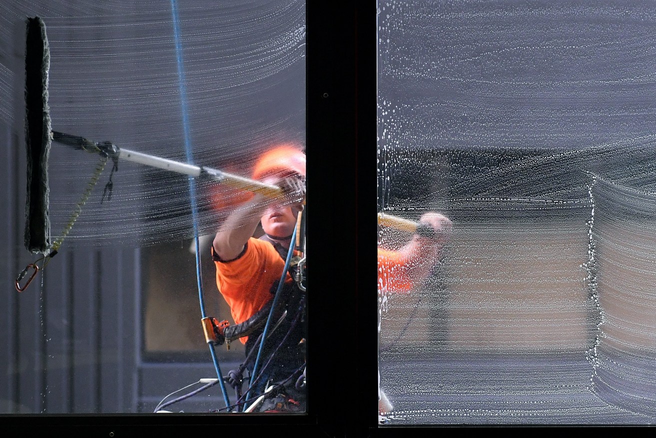 Stock photograph of a window cleaner in the central business district of Brisbane, March 27, 2017.  (AAP Image/Dave Hunt) 