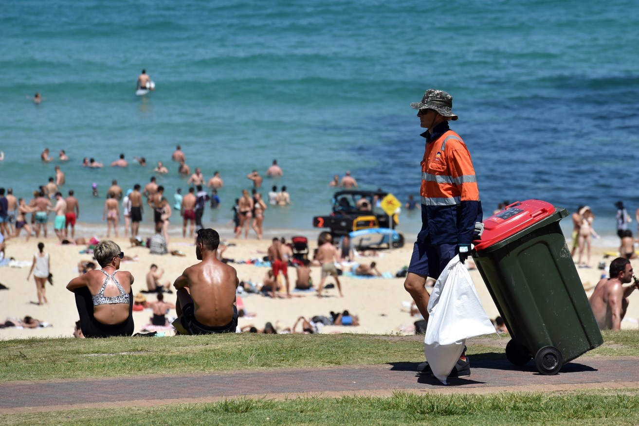 A council worker collects rubbish bins (AAP Image/Mick Tsikas) 