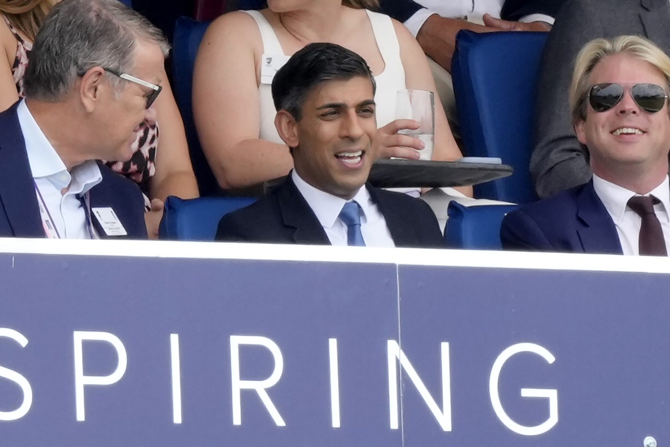 Britain's Prime Minister Rishi Sunak, center, watches the play on the fourth day of the second Ashes Test match between England and Australia, at Lord's cricket ground in London, Saturday, July 1, 2023. (AP Photo/Kirsty Wigglesworth)