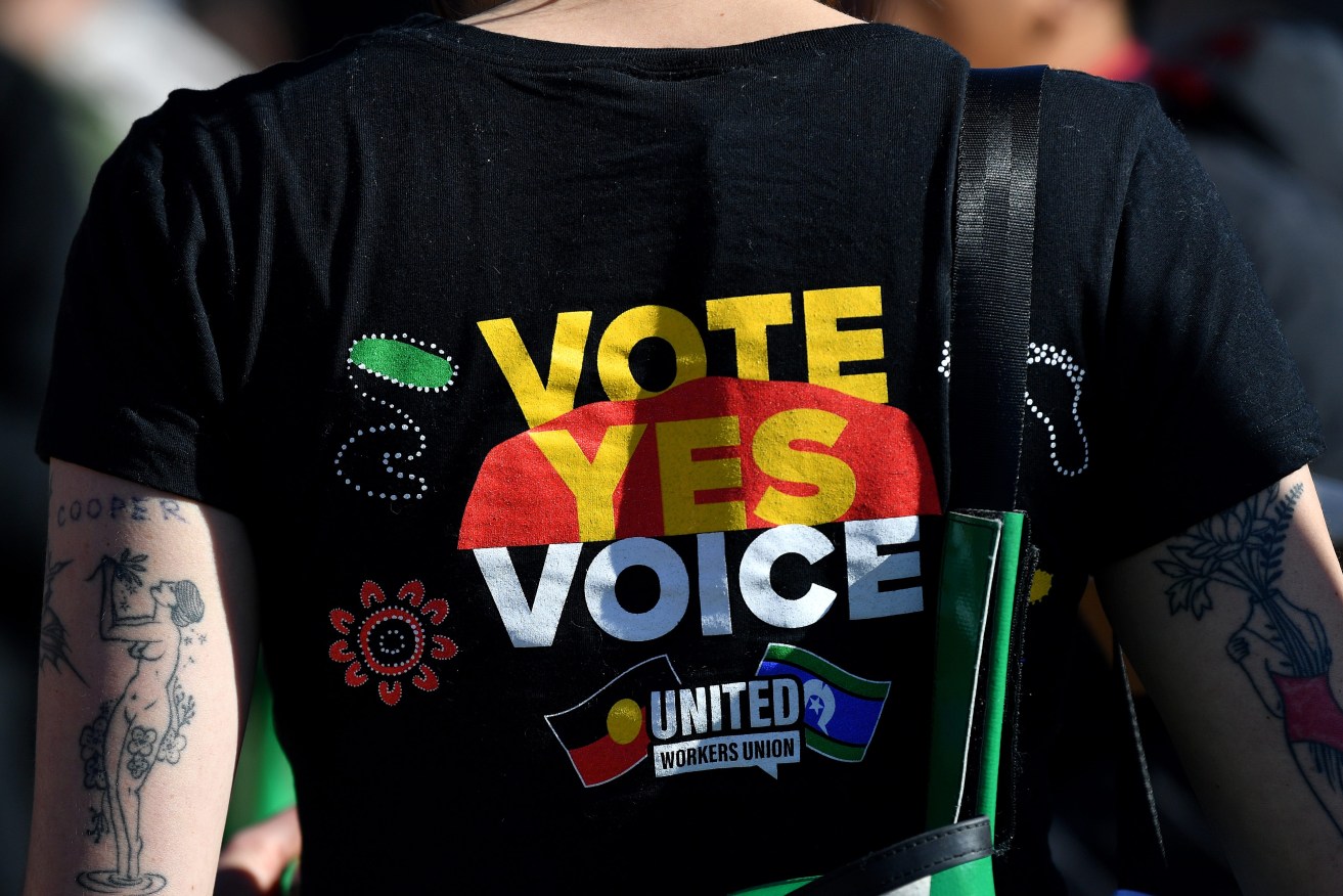 Supporters wear merchandise in support of a yes vote during a Yes 23 community event in support of an Indigenous Voice to Parliament, in Sydney, Sunday, July 2, 2023. (AAP Image/Bianca De Marchi)