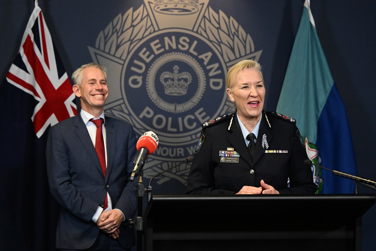 Federal Immigration Minister Andrew Giles (left) and Queensland Police Commissioner Katarina Carroll (right) are seen during a press conference at Queensland Police Service Headquarters, in Brisbane. (AAP Image/Darren England) 