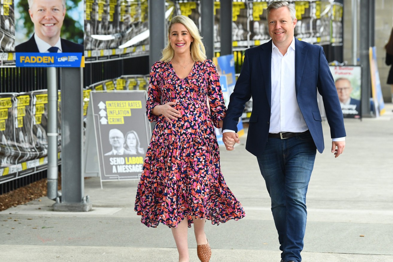 LNP's Cameron Caldwell and wife Lauren are seen during polling day for the by-election in the federal Queensland seat of Fadden, on the Gold Coast. (AAP Image/Jono Searle) 