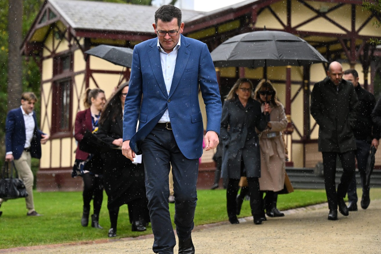 Victorian Premier Daniel Andrews cuts a lonely figure as he departs from a press conference to announce he has cancelled the 2026 Commonwealth Games, slated to be held across Victoria. (AAP Image/James Ross)