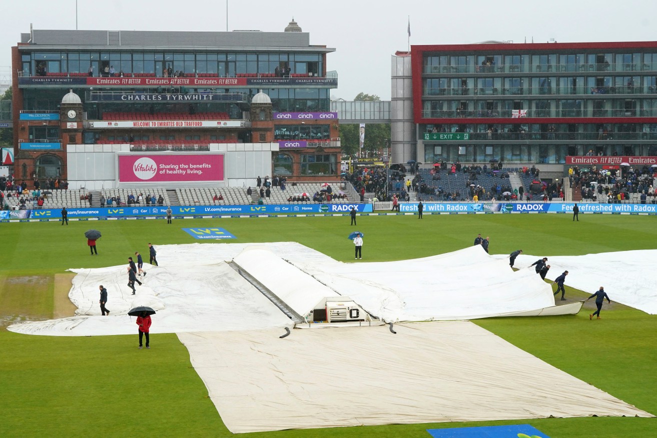 Rain covers protect the pitch during tea, on the fourth day of the fourth Ashes Test match between England and Australia at Old Trafford, Manchester, England, Saturday, July 22, 2023. (Nick Potts/PA via AP)