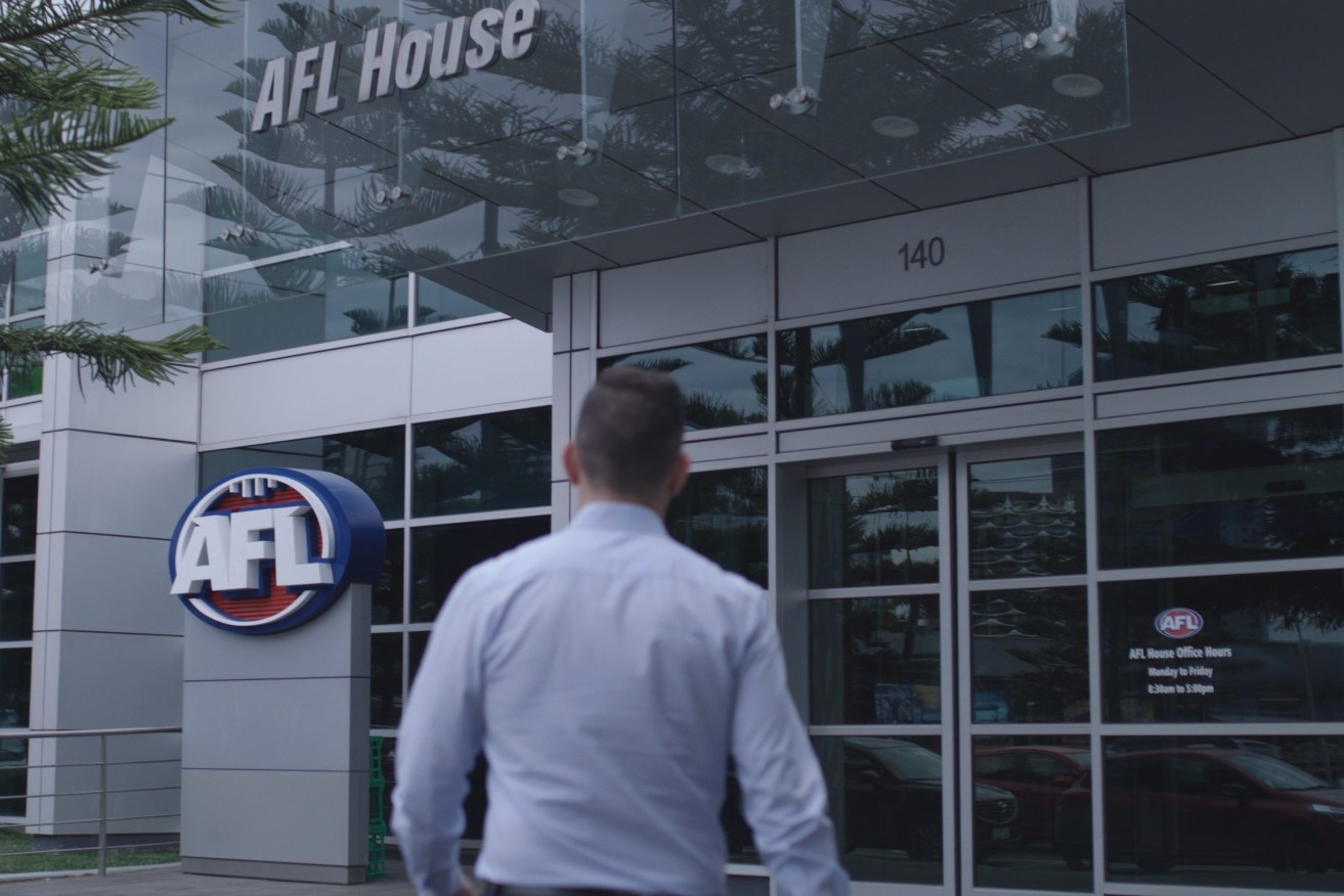 An employee at AFL headquarters, where the code has launched an urgent probe into the publication of 'intimate' players' photographs online. (Image: AFL)