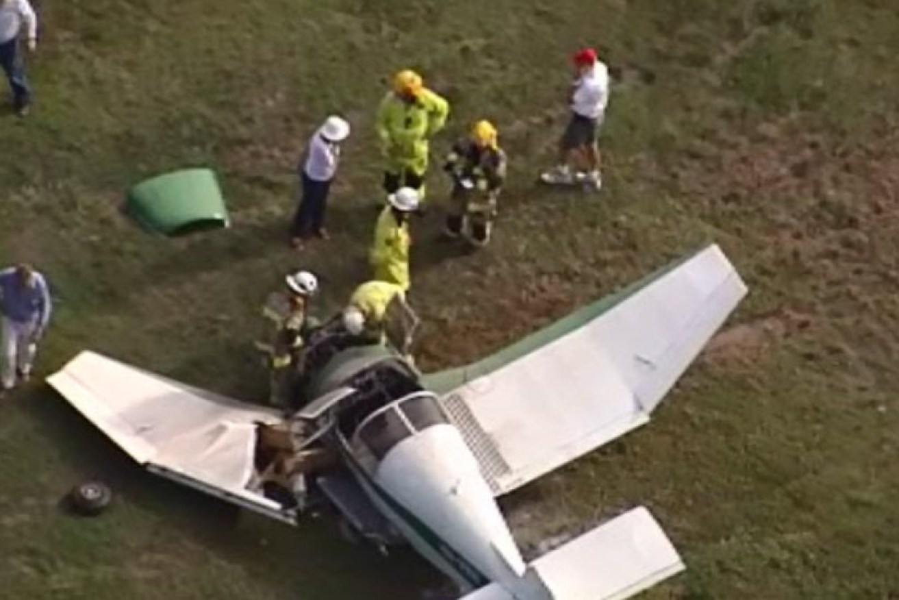 Emergency crews at the wreckage of one of two planes that collided mid-air at Caboolture Airport. (Channel 9 image)