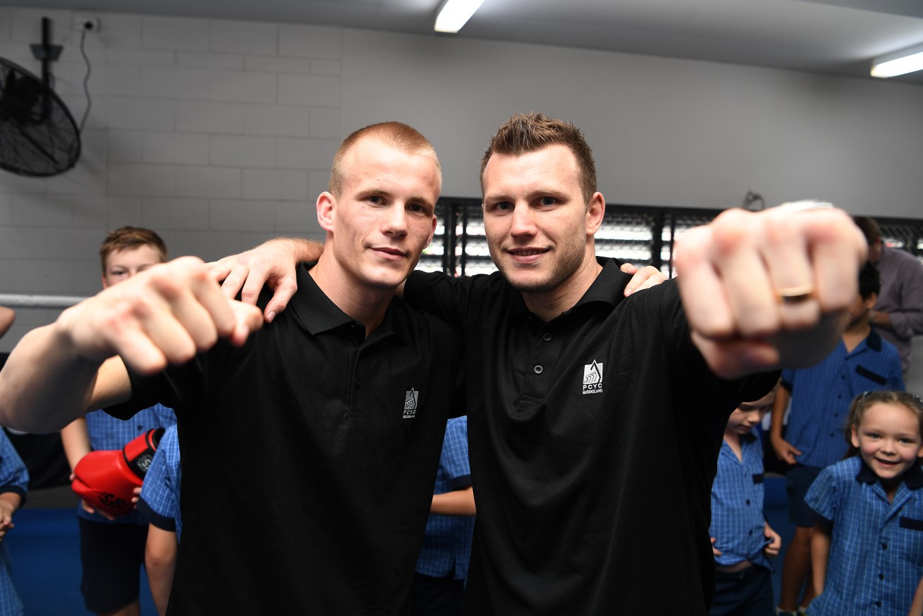 Former world champion Australian boxer Jeff Horn poses with fellow boxer Liam Wilson at a PCYC gym in Brisbane. PCYCs will get additional funding as an outlet for youth criminals (AAP Image/Dan Peled) 