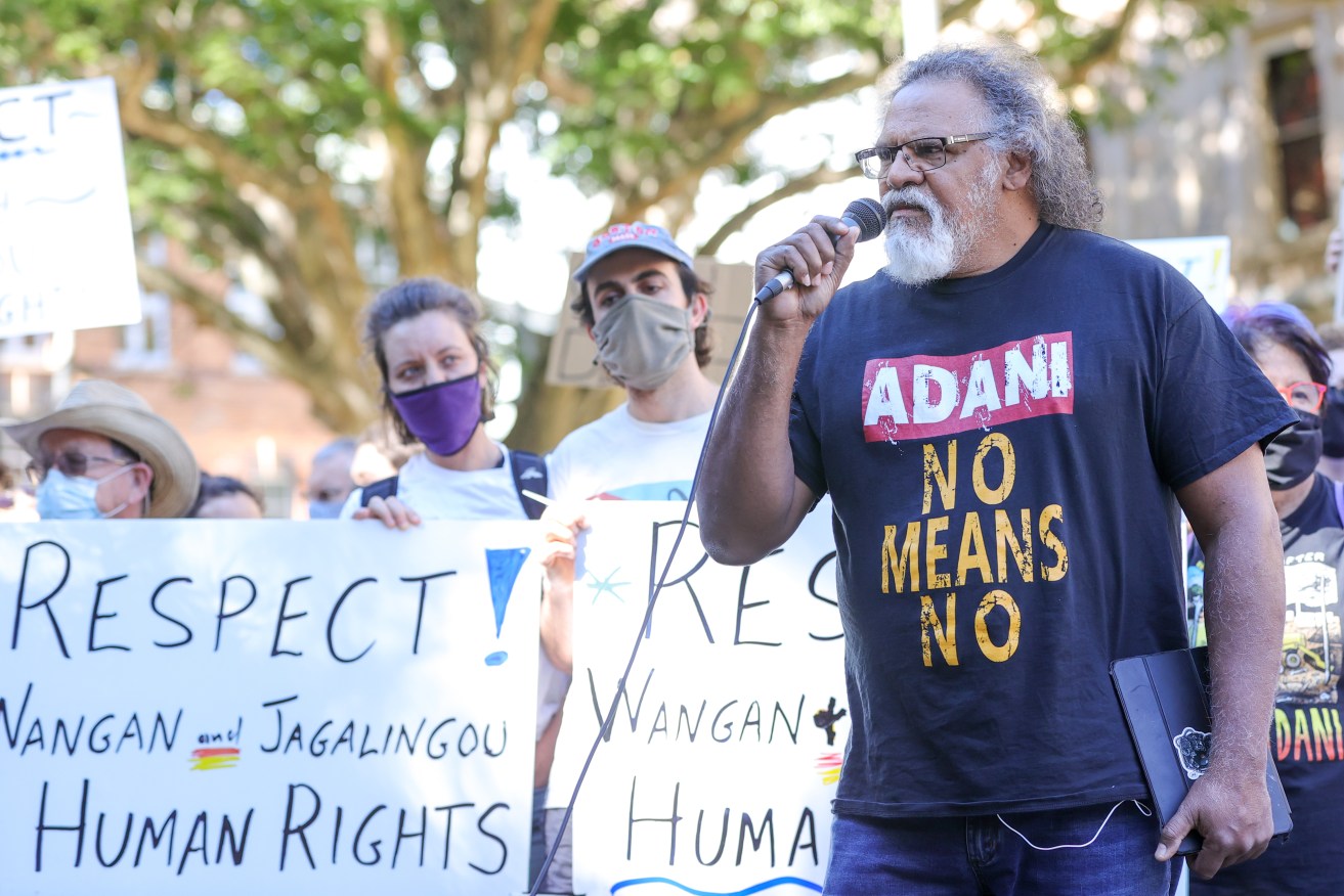 Tribal leader Adrian Burragubba speaks during a rally at Queensland Parliament in Brisbane, Monday, August 30, 2021. The Queensland government is being urged to intervene to ensure Bravus' controversial coal mine project is not draining a nearby nationally significant wetland. (AAP Image/Russell Freeman) NO ARCHIVING