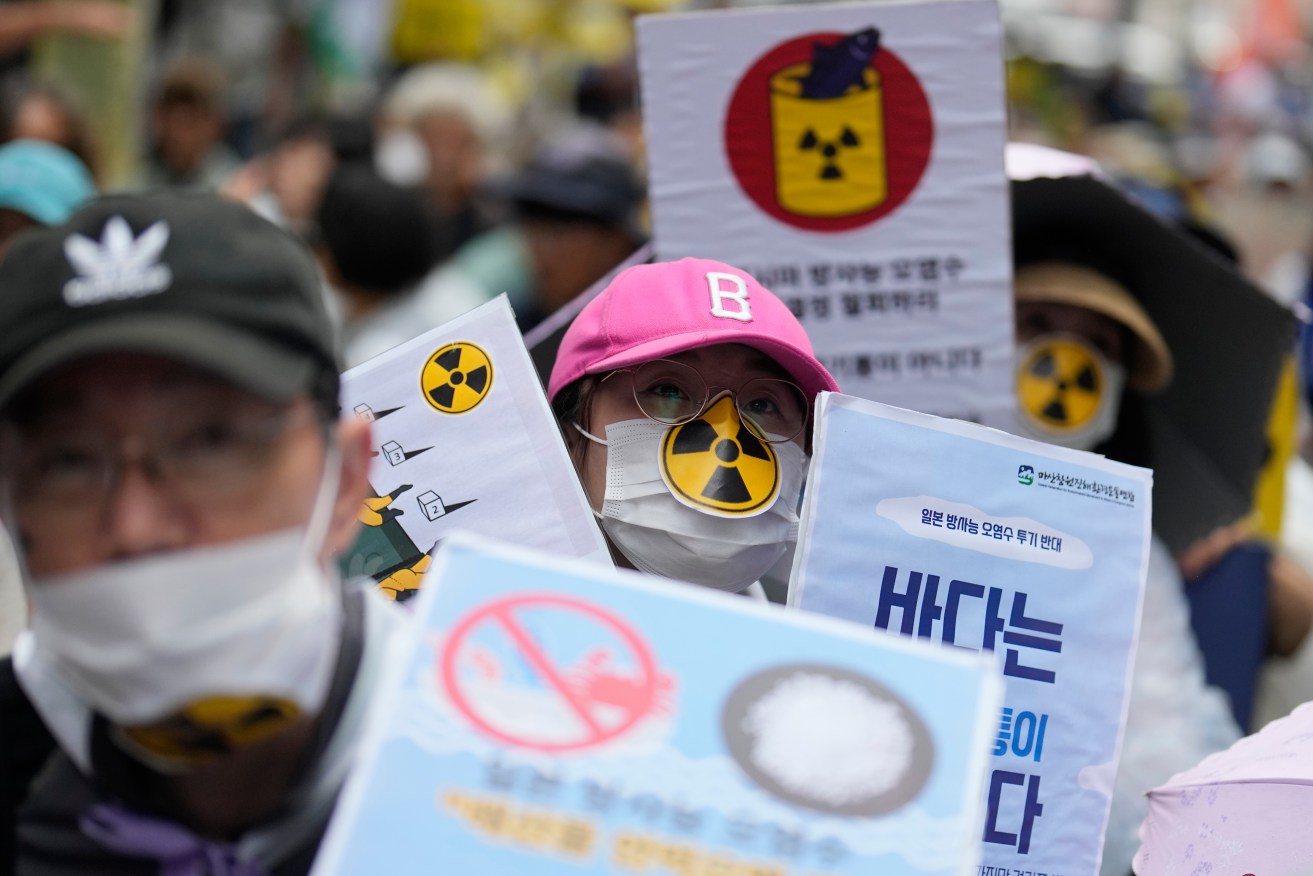 Members of civic groups attend a rally to oppose the Japanese government's plan to release treated radioactive water into the sea from the damaged Fukushima nuclear power plant, in Seoul, South Korea, Saturday, Aug. 12, 2023. Anxious about Japan’s impending release of treated nuclear wastewater from the tsunami-damaged Fukushima nuclear power plant, hundreds of South Koreans marched in their capital on Saturday. (AP Photo/Lee Jin-man)