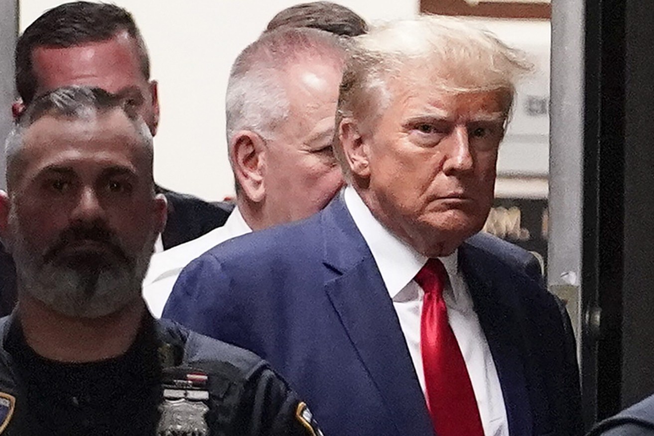 FILE - Former President Donald Trump is escorted to a courtroom, April 4, 2023, in New York. Trump’s bond has been set at $200,000 in the Georgia case accusing the former president of scheming to overturn his 2020 election loss. The bond agreement was outlined in a court filing signed by Fulton County District Attorney Fani Willis and Trump’s defense attorneys. (AP Photo/Mary Altaffer, File)