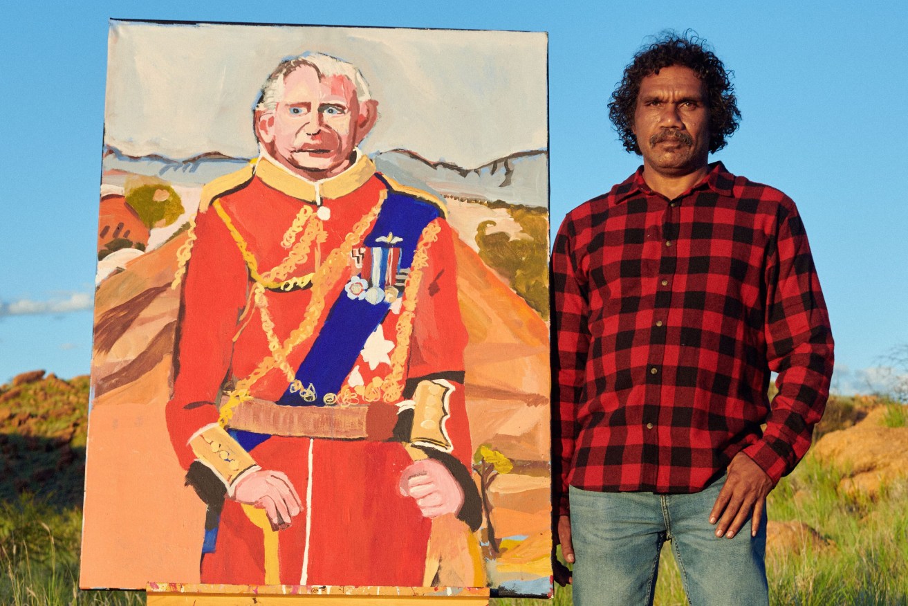 Artist Vincent Namatjira posing with artwork "Charles on Country in Mparntwe (Alice Springs),". New works by the Archibald prize winning artist will go on show in Sydney, ahead of a major survey show in Adelaide and Canberra. (AAP Image/Supplied by Jesse Lizotte, Iwantja Arts and Yavuz Gallery) 