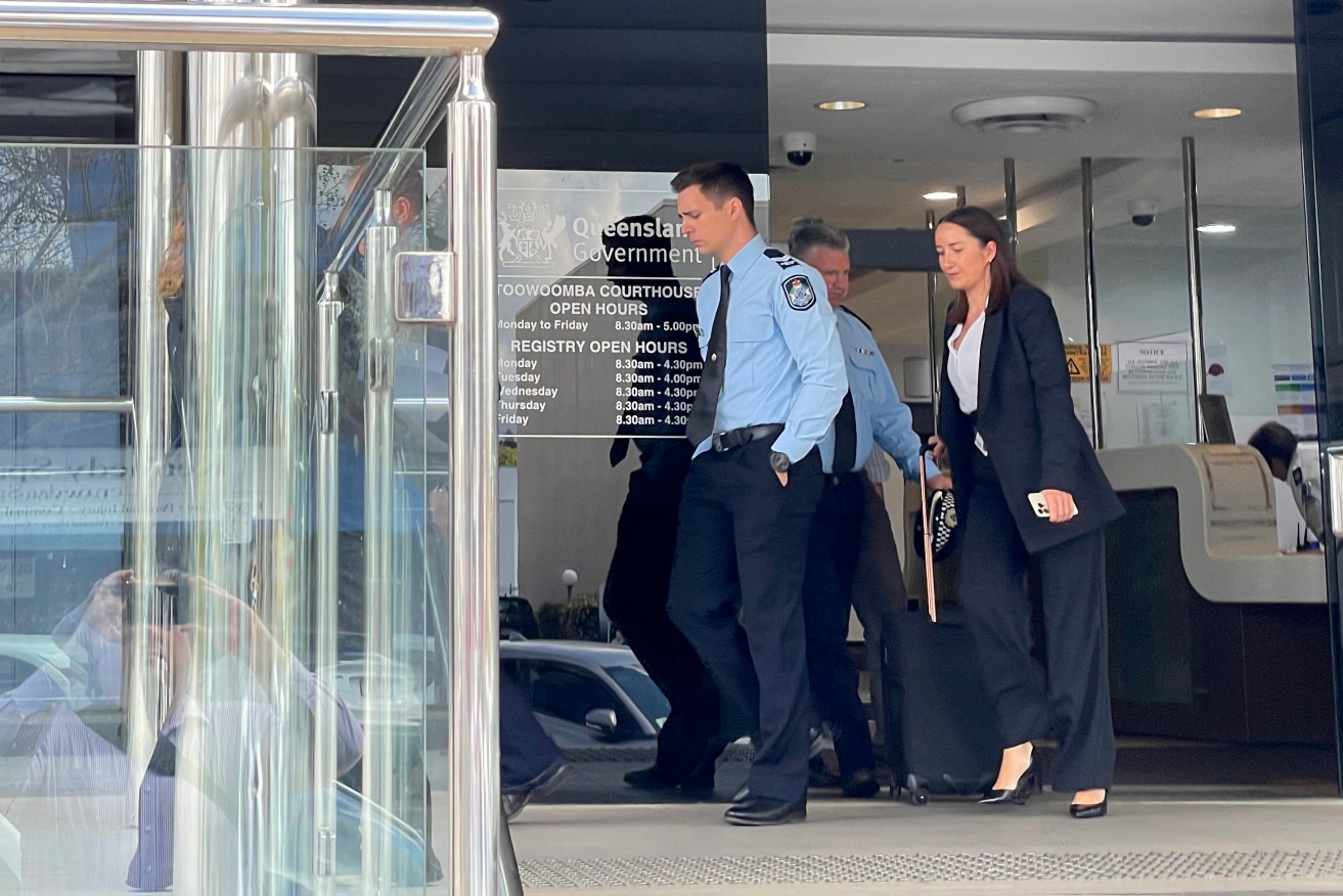 Senior Constable Jamie Williams (left) with solicitor Claire McGee (right) leaves Toowoomba Courthouse. (AAP Image/Rex Martinich)