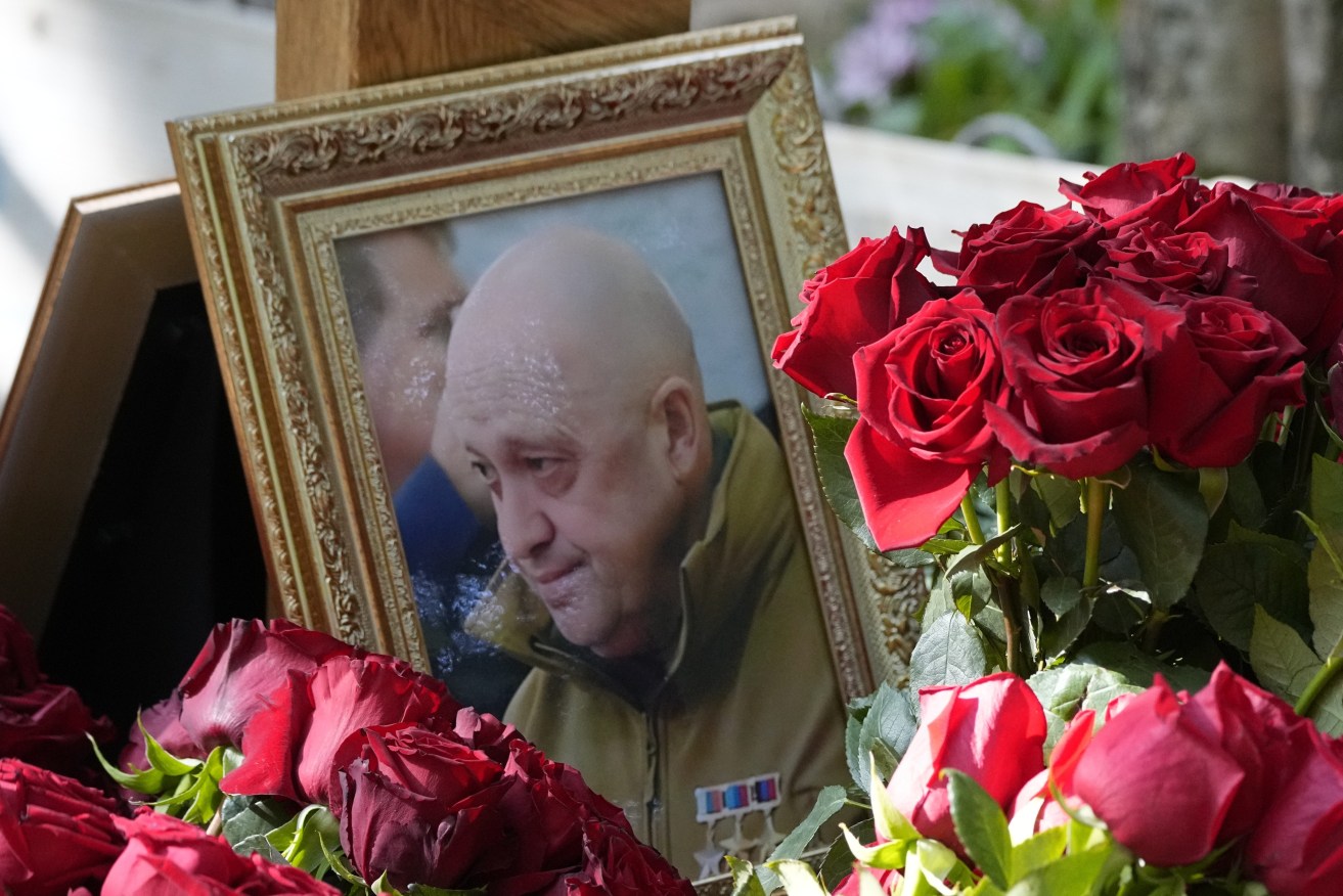 A portrait of Wagner Group's chief Yevgeny Prigozhin, who died last week in a plane crash two months after launching his brief rebellion, lies on flowers on the grave at the Porokhovskoye cemetery in St. Petersburg, Russia. (AP Photo/Dmitri Lovetsky)