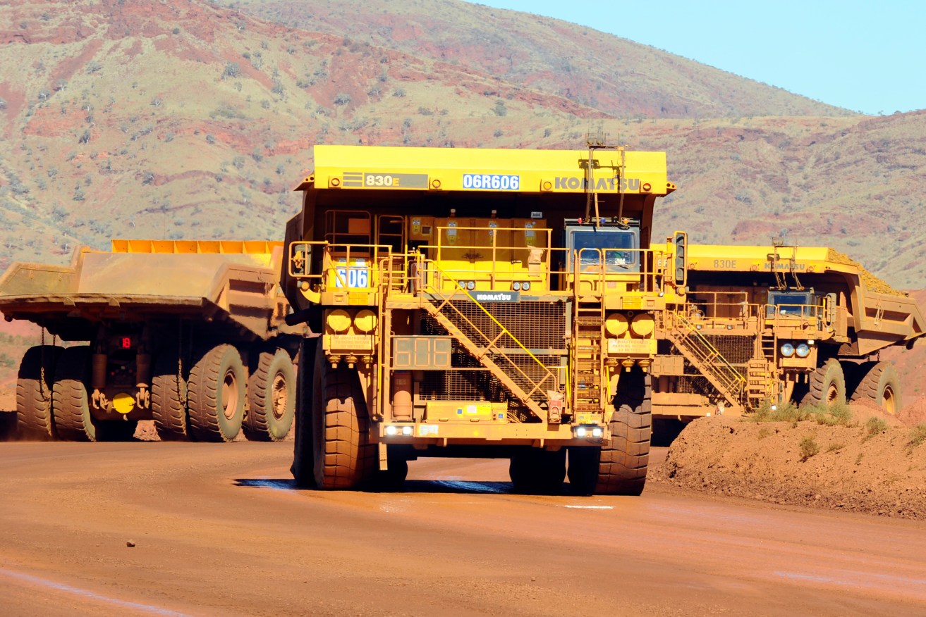 Haulage trucks at the Rio Tinto West Angelas iron ore mine in the Pilbara region of West Australia Wednesday, July 9, 2014.  (AAP Image/Alan Porritt) NO ARCHIVING