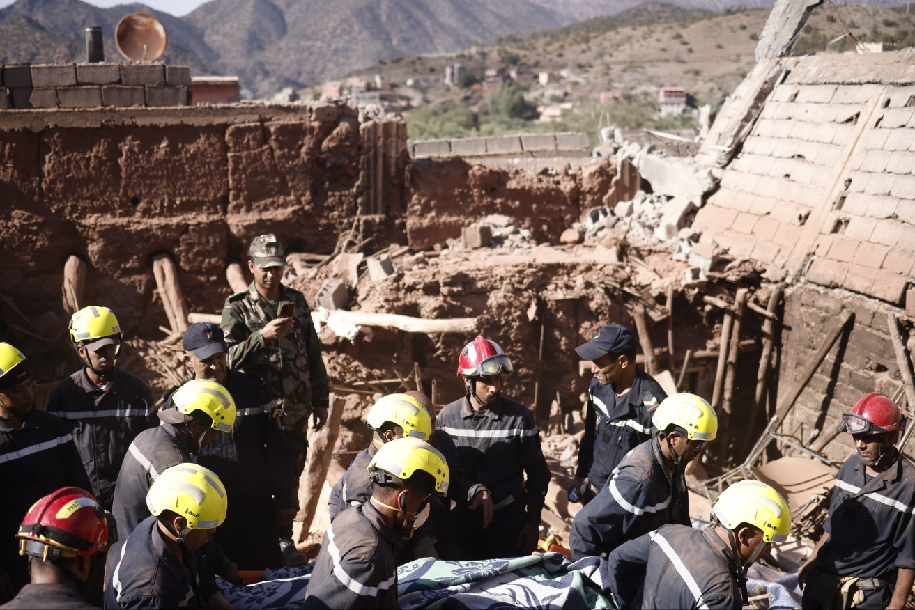  Rescue workers recover a victim's body during a rescue operation following a powerful earthquake in Ouirgane, south of Marrakesh, Morocco, 10 September 2023. A magnitude 6.8 earthquake that struck central Morocco late 08 September has killed at least 2,012 .  EPA/YOAN VALAT