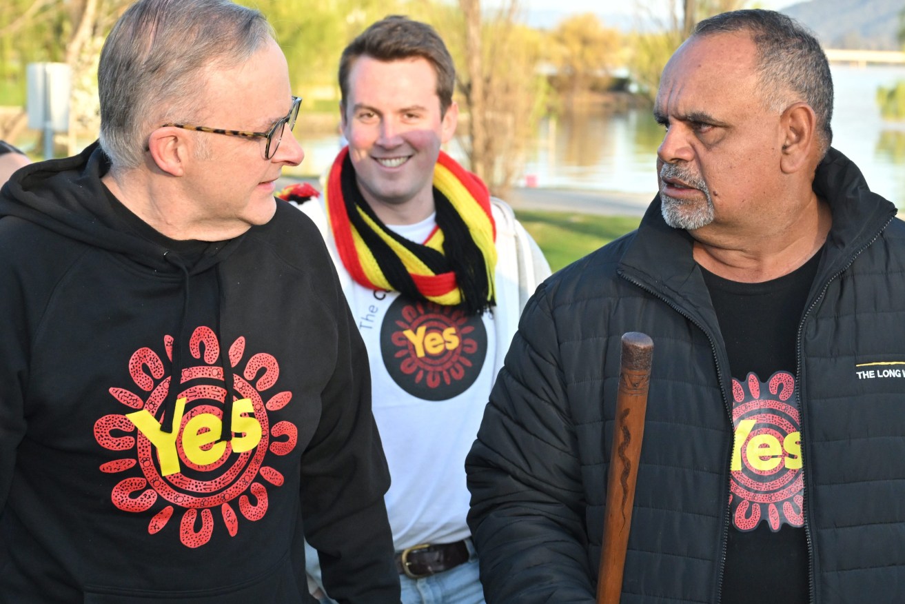 Prime Minister Anthony Albanese and former AFL player Michael Long walk to Parliament House at the completion of a 20 day long walk for the Yes campaign, in Canberra,  (AAP Image/Mick Tsikas) 