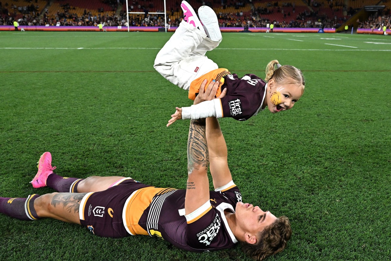 Reece Walsh of the Broncos reacts with daughter Leila following the NRL preliminary final between the Brisbane Broncos and the New Zealand Warriors at Suncorp Stadium in Brisbane, Saturday, September 23, 2023. (AAP Image/Dave Hunt) NO ARCHIVING, EDITORIAL USE  ONLY