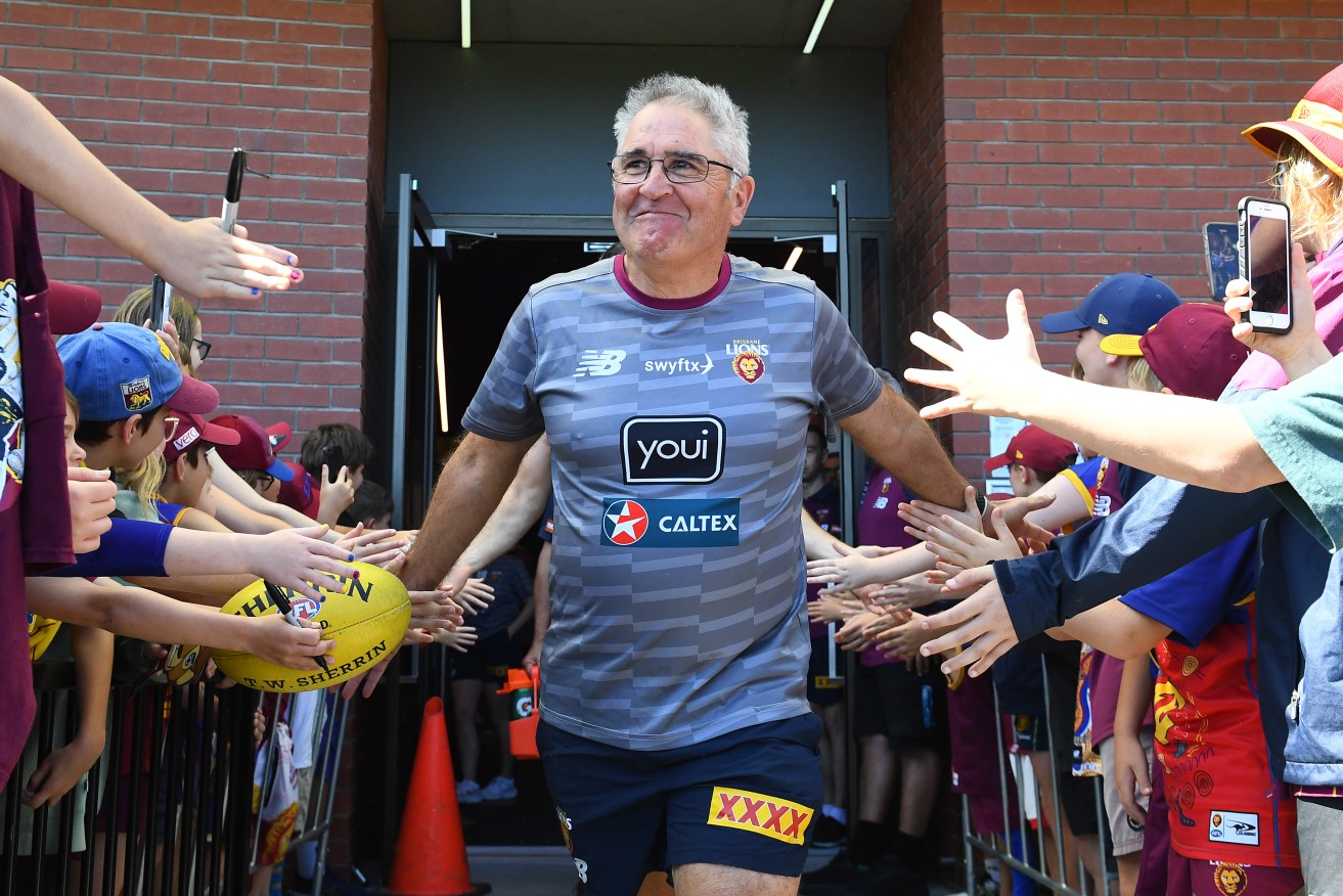 Lions coach Chris Fagan heads out during a Brisbane Lions AFL training session at Brighton Homes Arena in Brisbane. (AAP Image/Jono Searle)
