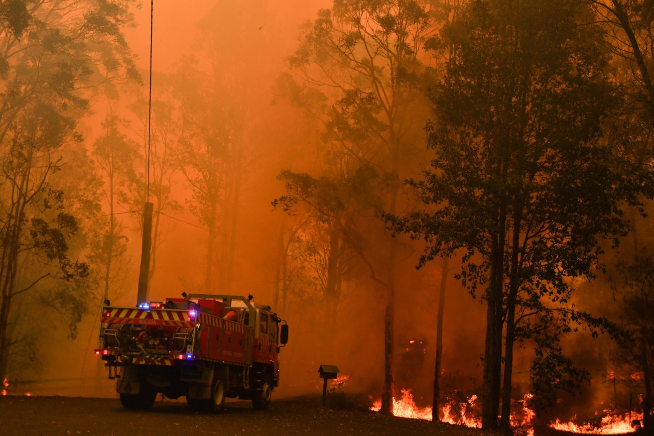 Fire trucks are seen during a bushfire in Werombi, 50km south west of Sydney, Friday, December 6, 2019. (AAP Image/Mick Tsikas) NO ARCHIVING